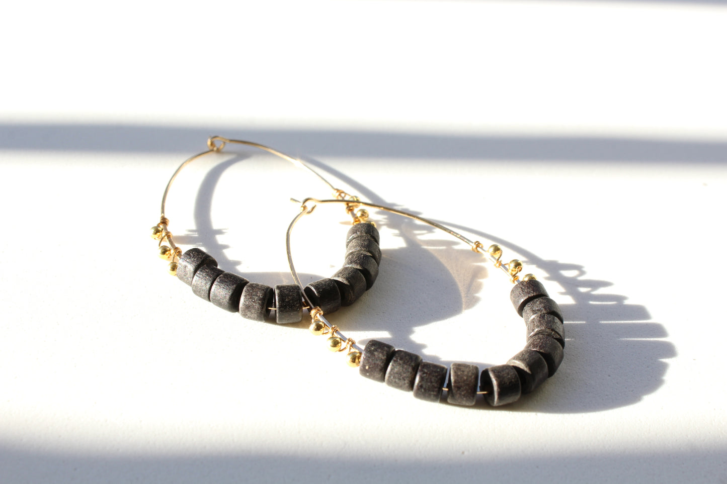 gold hoops with black beaded detail